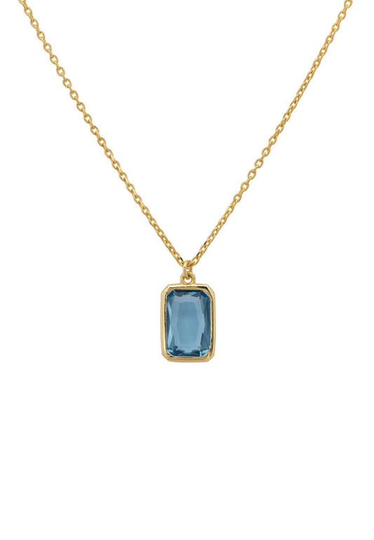 Blue topaz gold necklace on a display