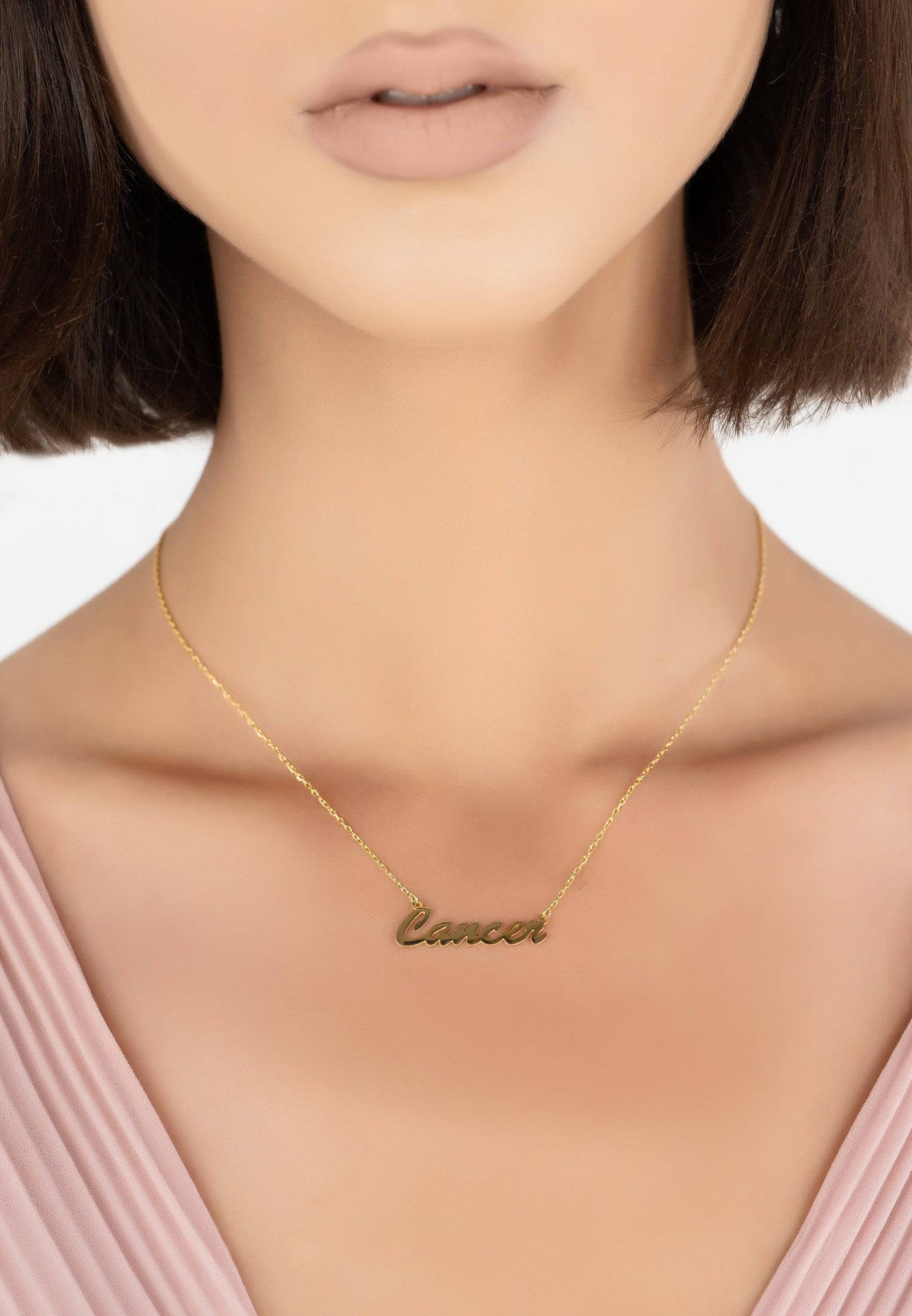 Cancer Name Necklace in Gold on Jewelry Display