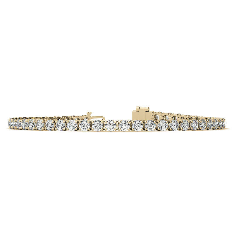 Gold bracelet with clear gemstones on a white background