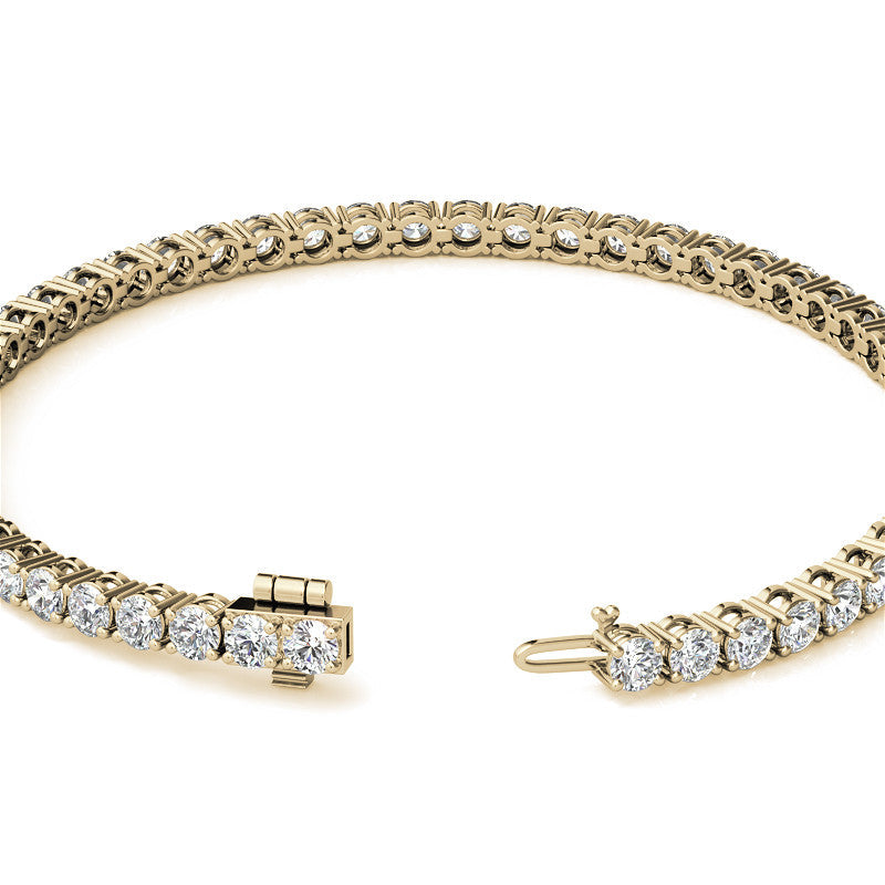 Gold bracelet with diamond accents on a white background