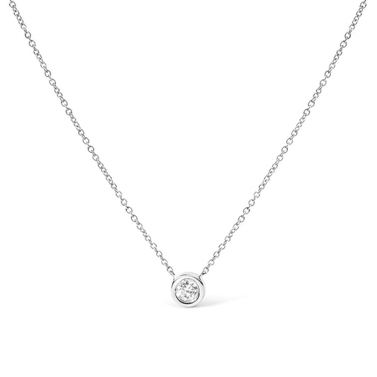 A 14K gold lab grown diamond solitaire bezel-set pendant necklace with an adjustable chain.