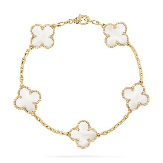Gold bracelet with white flower-shaped links on a white background